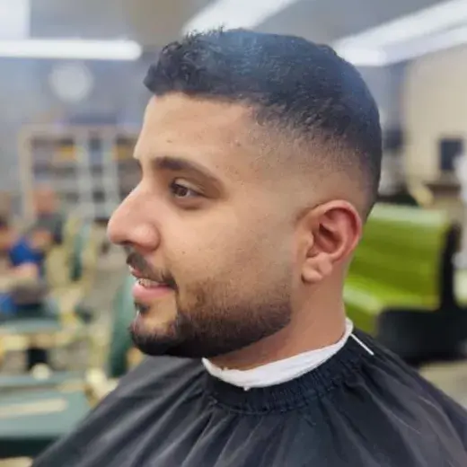 Short fade with a crisp front line up and a full beard